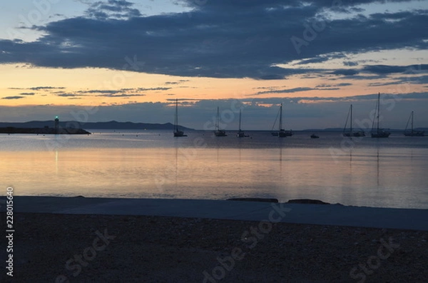 Fototapeta Morning sunrise at a small port with a silent ocean scenery in France