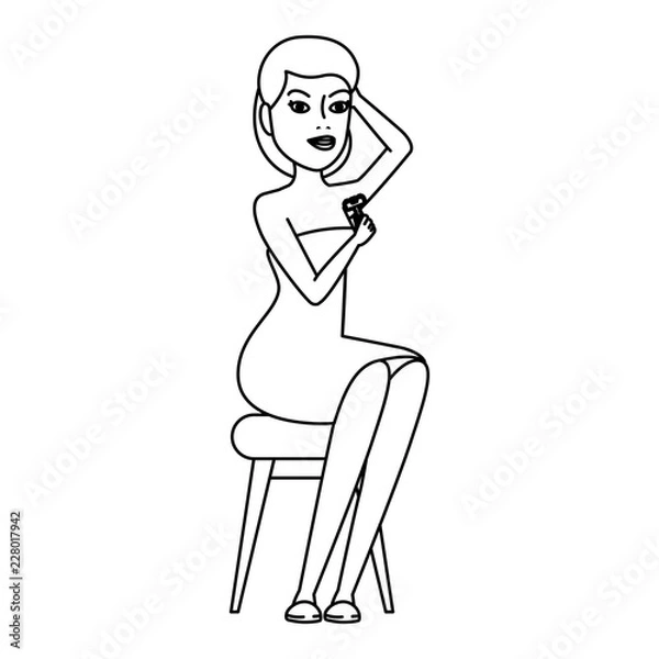 Fototapeta woman in towel waxing armpit with razor blade