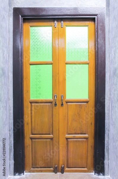 Obraz Vintage wooden door with Stained glass on the cement wall