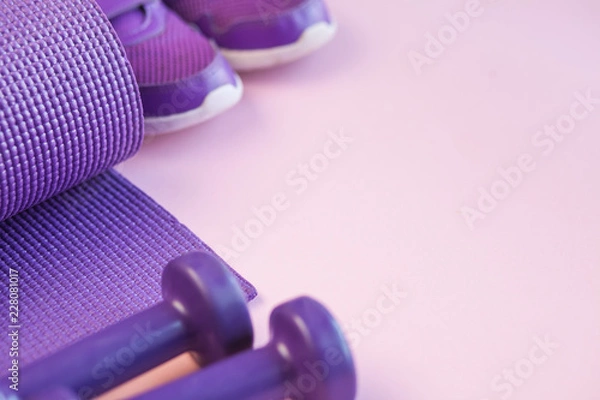 Fototapeta Sports background with copy space. Top view dumbbells, mat, and sneakers. Fitness concept. 