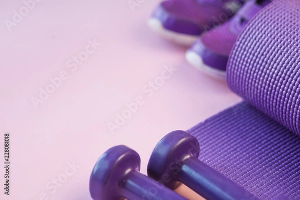 Fototapeta Sports background with copy space. Top view dumbbells, mat, and sneakers. Fitness concept. 