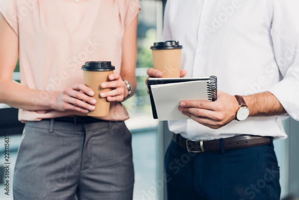 Fototapeta cropped shot of business colleagues with coffee to go in conference hall