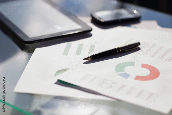 Obraz Financial paper charts and graphs on the table