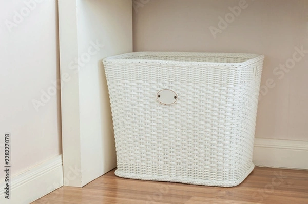 Obraz White Cloth basket on floor in room interior