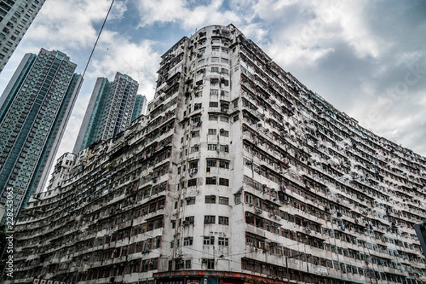 Obraz Old skyscraper during the day, endless windows, noir, moody dystopian old grey building