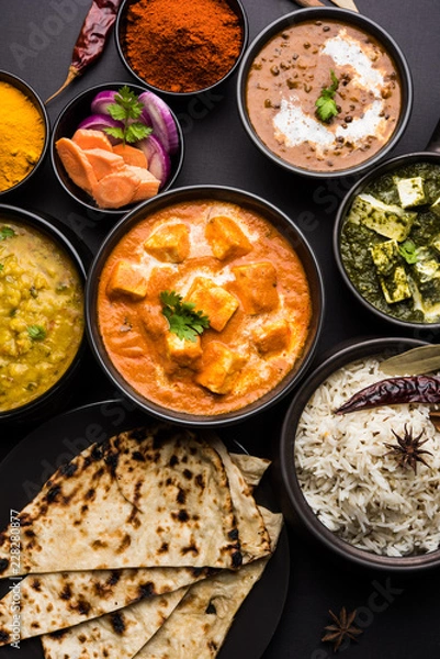 Obraz Indian Lunch / Dinner main course food in group includes Paneer Butter Masala, Dal Makhani, Palak Paneer, Roti, Rice etc, Selective focus