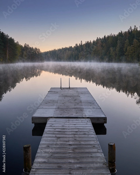 Obraz Scenic and idyllic lake landscape with pier and fog at autumn morning in Finland