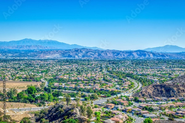 Obraz Road in the middle of suburbs on clear fall day