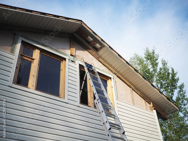 Obraz Construction of the frame house. Siding installation