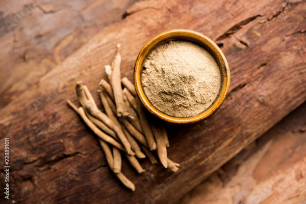 Obraz Ashwagandha / Aswaganda OR Indian Ginseng is an Ayurveda medicine in stem and powder form. Isolated on plain background. selective focus