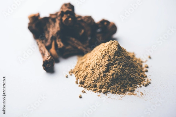 Fototapeta Hemidesmus indicus also known as Ananthamoola or Naruneendi or Nannari in dried steam and powder form. It's a useful Ayurvedic medicine from India