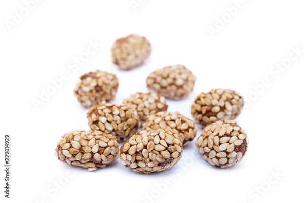 Fototapeta Coated peanuts with sesame isolated on white background