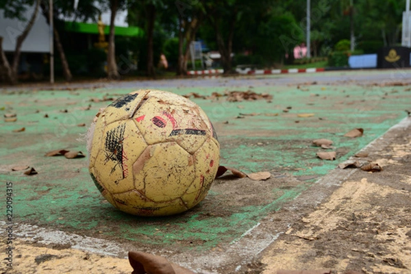 Obraz old ball on concrete field