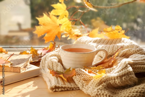 Obraz Cup of aromatic tea with warm plaid and autumn leaves on windowsill