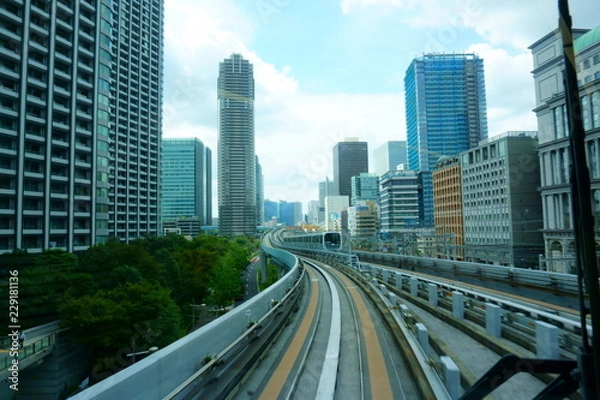 Fototapeta Scenery of a train traveling on the elevated rail of Yurikamome Line in Tokyo