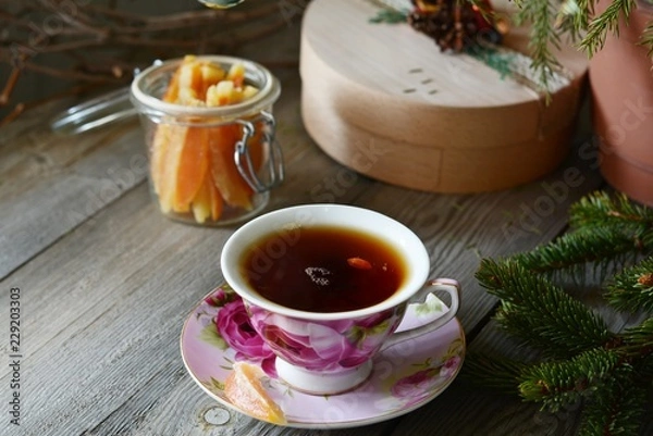 Fototapeta Delicious  Hot Cup of tea with christmas tree. Copy space. Christmas Background. Tea Time. Selective focus.