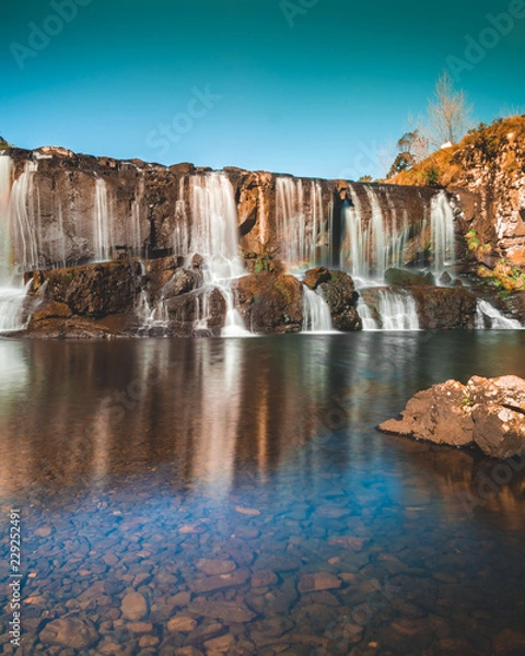 Fototapeta waterfall at sunset