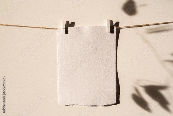 Fototapeta Empty handmade card mockup, Wall Art Mockup,Print hanger Mockup. Wall and leaves shadows in sunligjhts