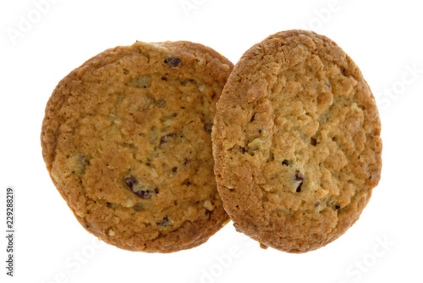 Fototapeta Top view of two cranberry and oat cookies isolated on a white background.