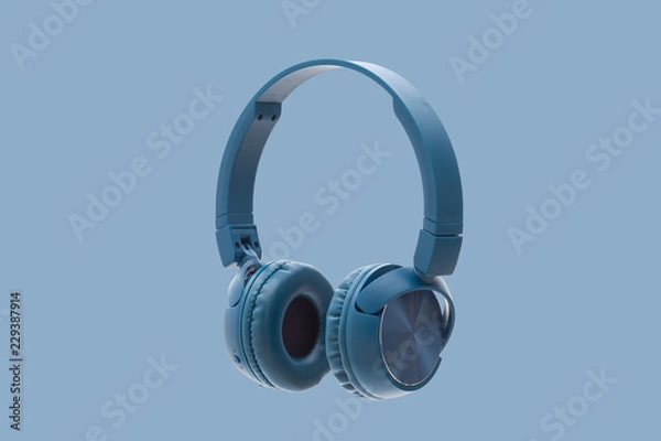 Obraz bluetooth blue headphone on blue background