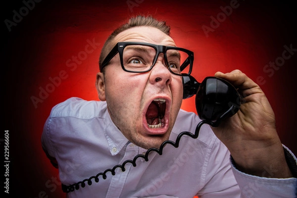 Obraz Hysterical and crazy boss screaming on the phone. Bad boss concept. Harassing phone calls.