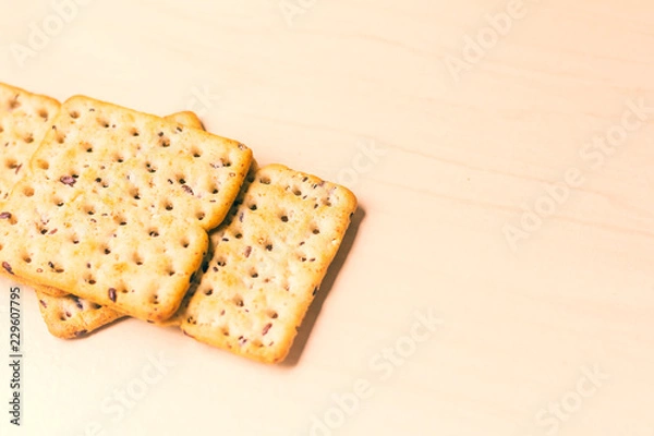 Fototapeta Full-grain cereal biscuits on light background and space for text.