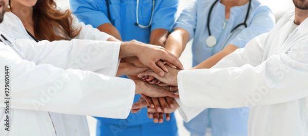 Obraz Doctors and nurses stacking hands. concept of mutual aid.
