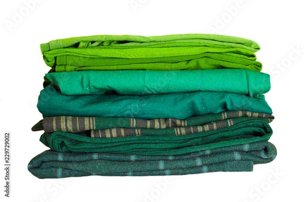 Fototapeta Stack green winter clothes isolated on white background