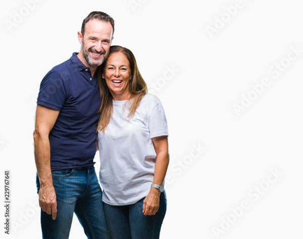 Fototapeta Middle age hispanic casual couple over isolated background with a happy and cool smile on face. Lucky person.