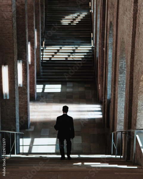 Obraz man coming down the stairs