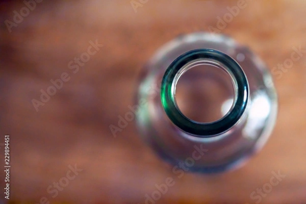 Fototapeta Top View Of A Bottleneck, Empty Bottle On A Wooden Table. Healthy Living And Detox Concept. Abstinence, Alcoholism Treatment. New Year’s Resolutions. Becoming A New You, Promising A Better Life.