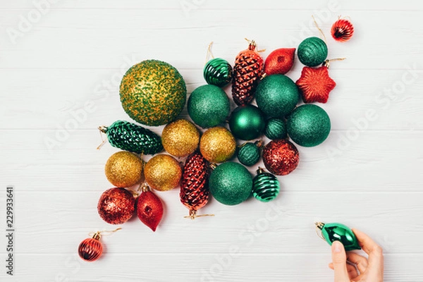 Fototapeta Christmas decorations balls on white table, top view