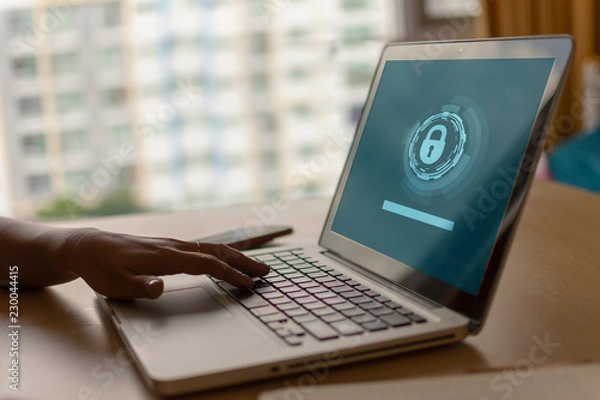 Fototapeta Using a laptop to connect to a network and is protected by a network security system. Warm colors