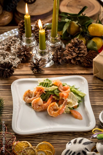 Obraz Seafood Green Salad with Salmon, Avocado and Shrimps on white plate on christmas decorated background