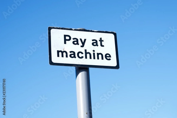 Fototapeta Pay at machine sign against empty blue sky
