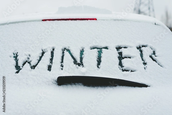 Obraz Closeup of snow covered car with word "winter" written on rear window