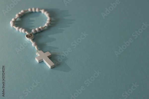Obraz white rosary on blue background