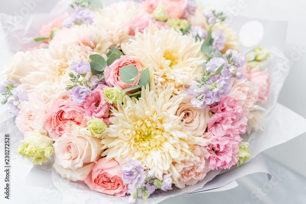 Fototapeta Beautiful spring bouquet in glass vase. Arrangement with various flowers. The concept of a flower shop. A set of photos for a site or catalogue. Work florist.