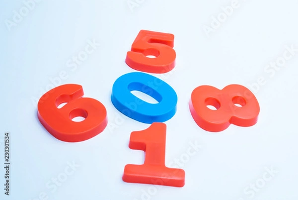 Fototapeta Multicolored numerals arranged chaotically on a white background