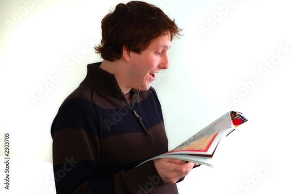 Obraz young man reading a magazine