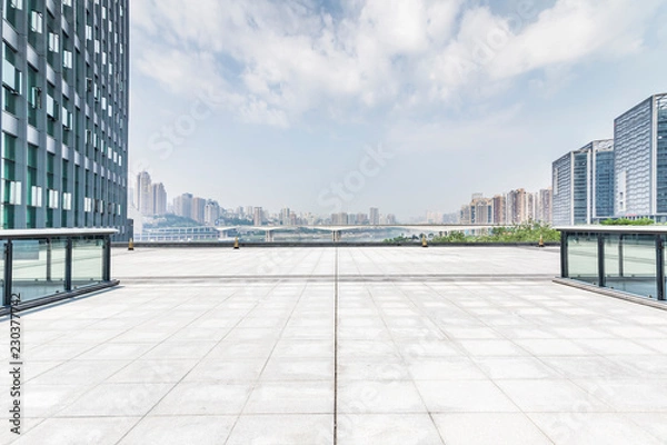 Fototapeta Panoramic skyline and modern business office buildings with empty road,empty concrete square floor