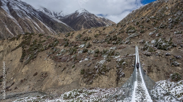 Fototapeta Suspensin Bridge going over a River on Annapurna Circuit