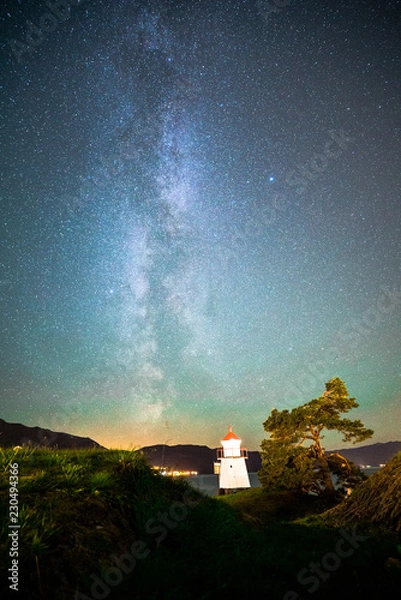 Obraz Beautiful Night Sky Milky Way Stars Galaxy with Lighthouse on Ocean Water Coast in Norway Scandinavia