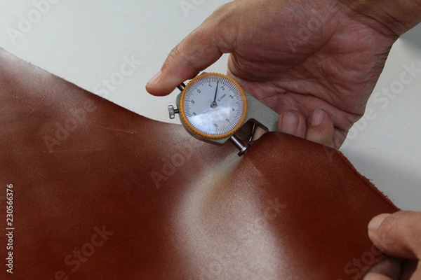 Fototapeta hand held thickness gauge tester tool measure brown leather