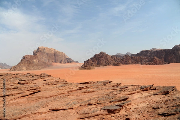 Fototapeta Red mountains of the canyon of Wadi Rum desert in Jordan. Wadi Rum also known as The Valley of the Moon is a valley cut into the sandstone and granite rock in southern Jordan to the east of Aqaba