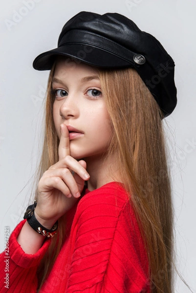 Fototapeta Close-up portrait of beautiful young redhead girl wearing red sweater posing in studio.