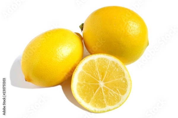 Fototapeta two bright yellow lemons and half lemon on white isolate background