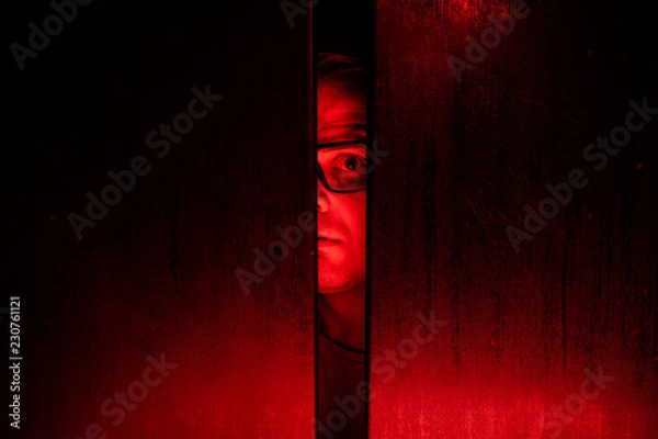 Obraz Agoraphobia concept / eye peeking behind the door