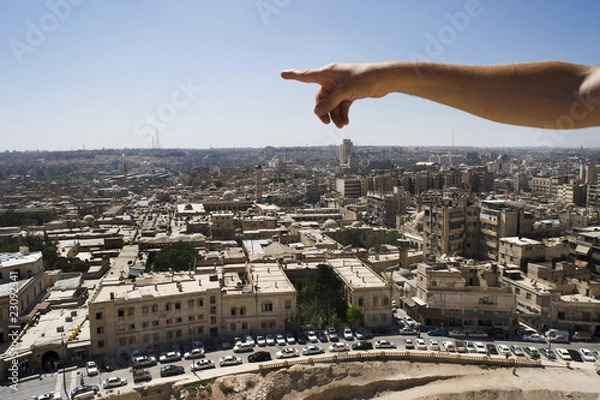 Fototapeta Man pointing to the infinite over the city of Aleppo, Syria