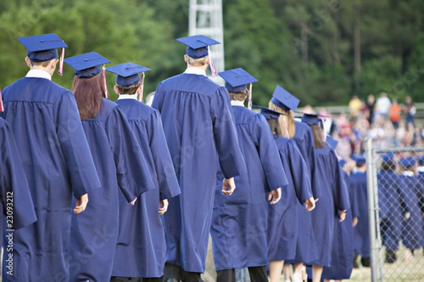 Obraz Line of school graduates in blue caps and gowns